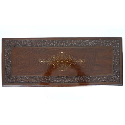 875 - A modern Indian hardwood bookcase with two drawers, floral carved in low relief and inlaid with bras... 