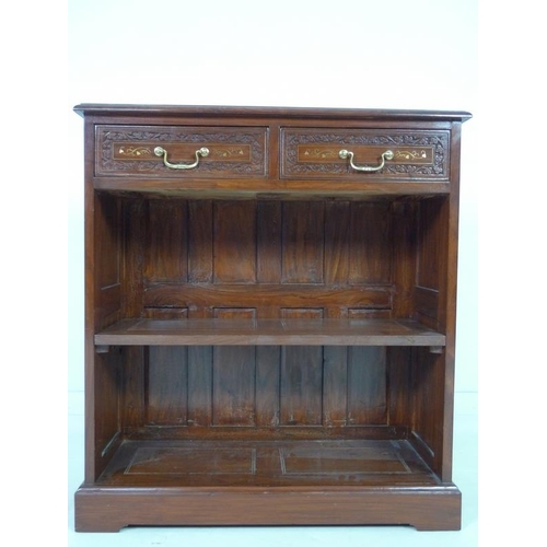 875 - A modern Indian hardwood bookcase with two drawers, floral carved in low relief and inlaid with bras... 