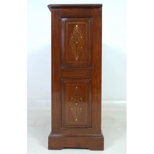 875 - A modern Indian hardwood bookcase with two drawers, floral carved in low relief and inlaid with bras... 