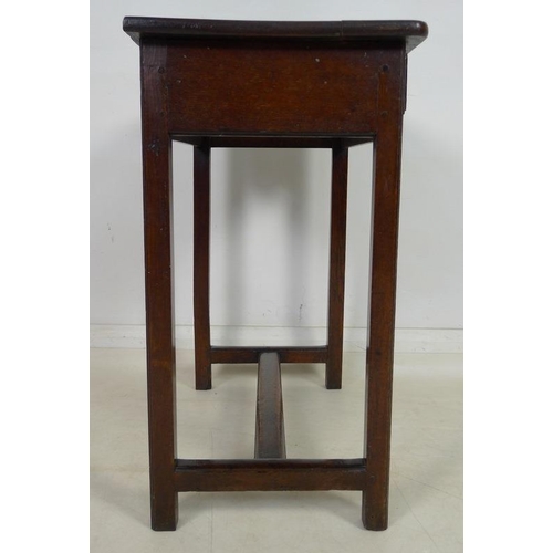 878 - An early 18th century oak side table, single frieze drawer with moulded edges, brass drop handles an... 