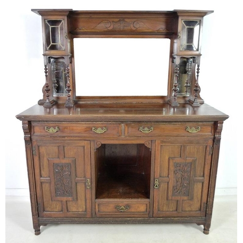 879 - An Edwardian mahogany sideboard, mirrored back with bevelled plates, two small lead glazed cupboards... 