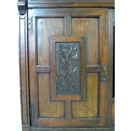 879 - An Edwardian mahogany sideboard, mirrored back with bevelled plates, two small lead glazed cupboards... 