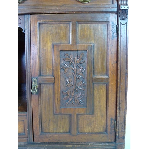 879 - An Edwardian mahogany sideboard, mirrored back with bevelled plates, two small lead glazed cupboards... 