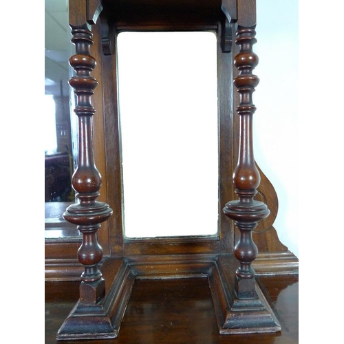 879 - An Edwardian mahogany sideboard, mirrored back with bevelled plates, two small lead glazed cupboards... 