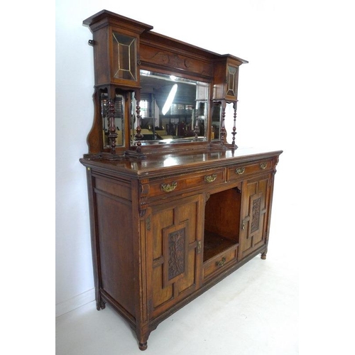 879 - An Edwardian mahogany sideboard, mirrored back with bevelled plates, two small lead glazed cupboards... 