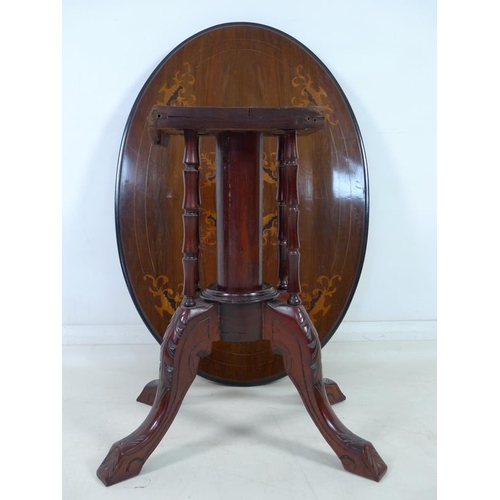 882A - A late Victorian oval occasional table, with marquetry inlaid top decorated with urns and scrolls, o... 