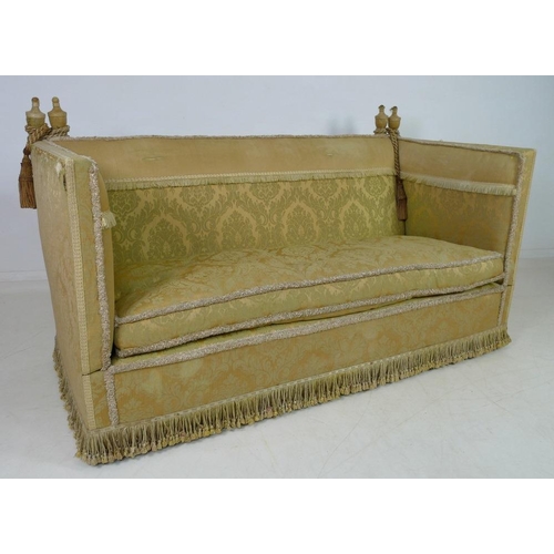 948 - A Knowle settee, circa 1920, upholstered in gold coloured brocade with fringing to the back, sprung ... 