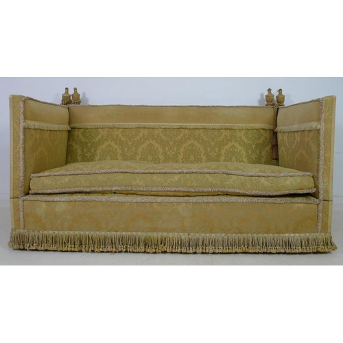 948 - A Knowle settee, circa 1920, upholstered in gold coloured brocade with fringing to the back, sprung ... 