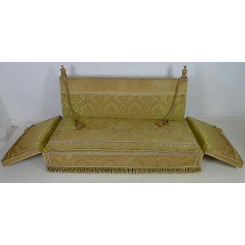 948 - A Knowle settee, circa 1920, upholstered in gold coloured brocade with fringing to the back, sprung ... 