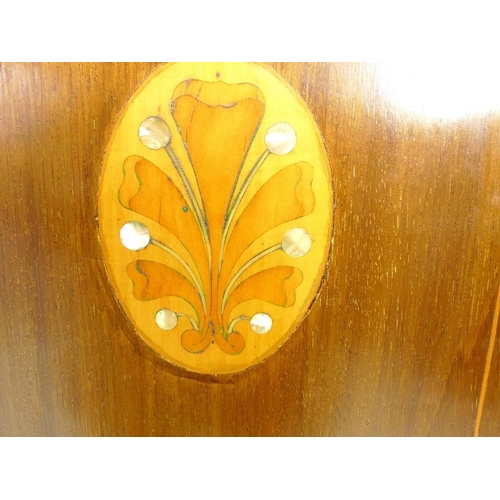 953 - An Edwardian mahogany gentleman's wardrobe, decorated with inlaid fruitwood and mother of pearl pane... 