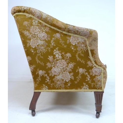 955 - A Victorian two seater settee, with bolster top rail and shaped arms, bowed front and overstuffed se... 