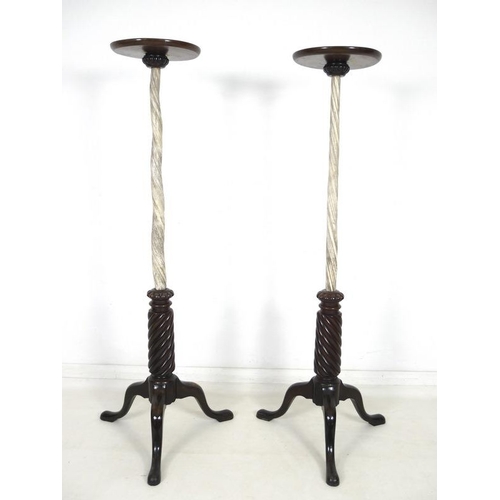 958 - A pair of late Victorian narwhal tusk torchere stands, each mounted with dished mahogany circular su... 