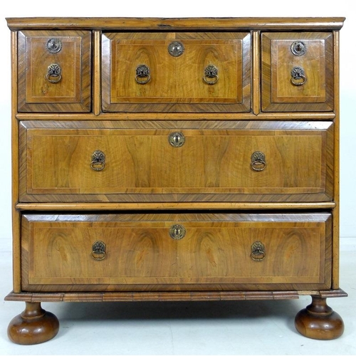 959 - A Queen Anne walnut chest of drawers, circa 1710, crossbanded, inlaid with stringing and feather ban... 