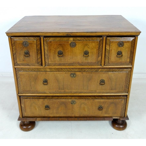 959 - A Queen Anne walnut chest of drawers, circa 1710, crossbanded, inlaid with stringing and feather ban... 