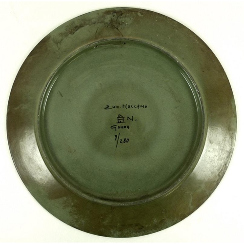 522 - A large Gouda, Holland charger, a limited edition 1/120, hand decorated with a green background to t... 