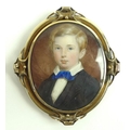 A 19th century miniature on ivory of a young boy, circa 1870, wearing a blue ribbon to his collar, s... 