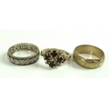 A group of three gold rings, comprising a 9ct gold ring set with four garnets, size M, 3.3g, a 9ct g... 