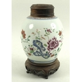 A Chinese porcelain ginger jar, 18th or 19th century, the body decorated with peonies and foliage, b... 
