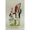 A Victorian Staffordshire Crimean group, modelled as a sailor standing holding a Russian Naval Ensig... 