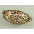 A Royal Crown Derby Imari lozenge shaped dish, with pierced handles, raised on four bracket feet, pa... 