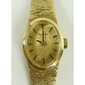 A Bulova 9ct gold cased lady's wristwatch, circa 1970's, oval gold dial with subtle floral acid etch... 