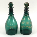 A pair of George III mallet form green glass decanters and stoppers, three trailed rings to the neck... 