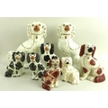 A collection of ceramic Staffordshire models of spaniels, the larger pair 33cm high, the smaller pai... 