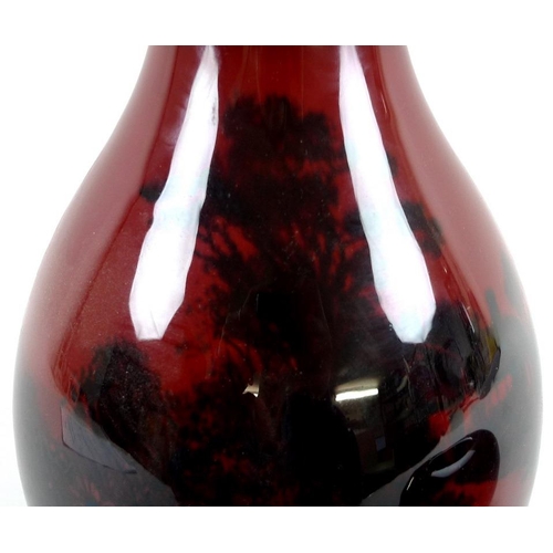 540 - A Royal Doulton Flambe vase of ovoid form with narrow neck, decorated in dark reds with a silhouette... 