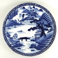 A Chinese porcelain blue and white charger, early 20th century, decorated with mountainous landscape... 