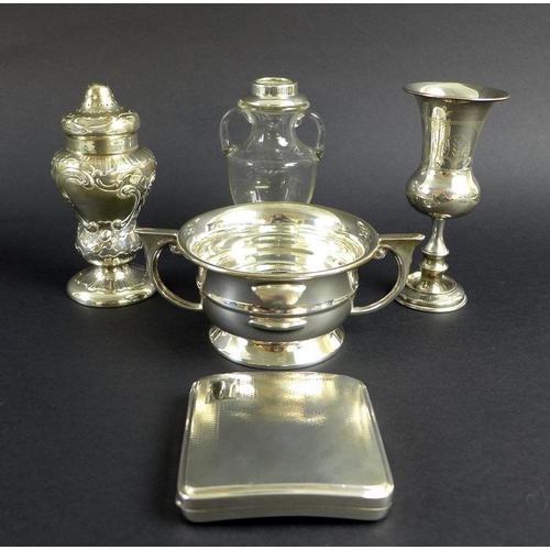 759 - An unusual Victorian silver pepper pot, the curved body chased and embossed with scrolls and foliage... 