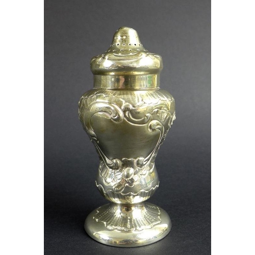 759 - An unusual Victorian silver pepper pot, the curved body chased and embossed with scrolls and foliage... 