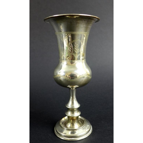 759 - An unusual Victorian silver pepper pot, the curved body chased and embossed with scrolls and foliage... 