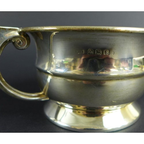 759 - An unusual Victorian silver pepper pot, the curved body chased and embossed with scrolls and foliage... 