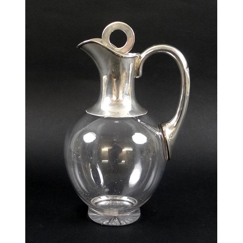 760 - A George V silver topped claret jug, the rounded clear glass body with star cut foot, with plain col... 