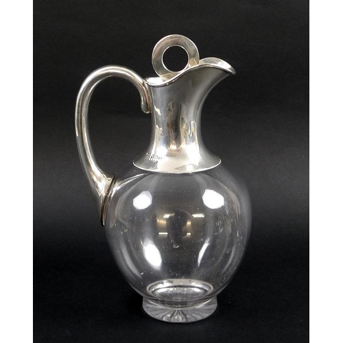 760 - A George V silver topped claret jug, the rounded clear glass body with star cut foot, with plain col... 