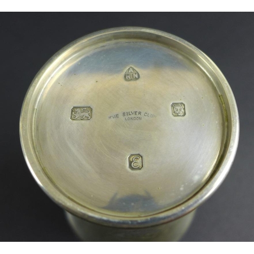 766 - A group of Victorian and later silver items comprising a beaker engraved with strap work design and ... 