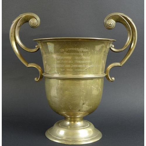 767 - A large Edward VII silver trophy, the urn form body with two scroll handles, engraved '10 Stone Cup,... 