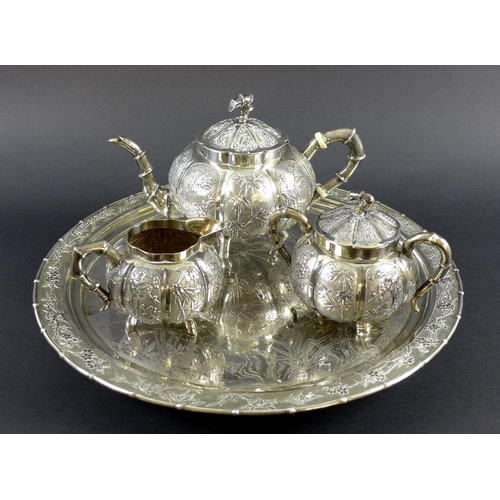 770 - A Chinese Export four piece silver tea service including tray, circa 1900, each of lobed melon form ... 