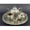 A Chinese Export four piece silver tea service including tray, circa 1900, each of lobed melon form ... 