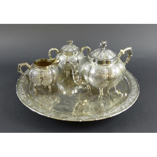 770 - A Chinese Export four piece silver tea service including tray, circa 1900, each of lobed melon form ... 