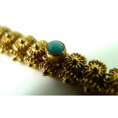 807 - A 14ct gold bracelet set with turquoise cabochons on an intricately beaded articulated band, marked ... 