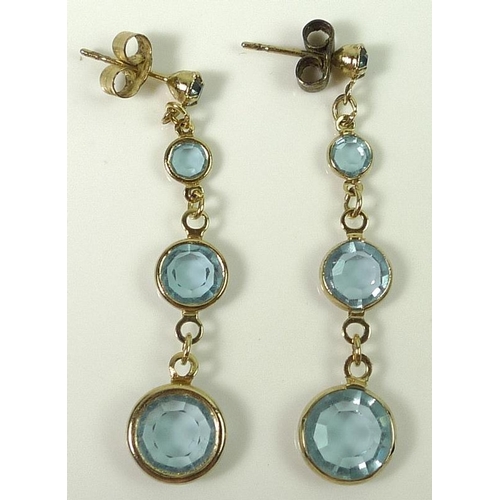 811 - A pair of drop earrings each set with four aquamarines of graduated size, 4 cm in length, with 9ct g... 