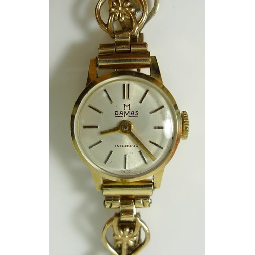 814 - A lady's 14ct gold watch with 9ct gold bracelet strap, the strap delicately formed with daisies to e... 