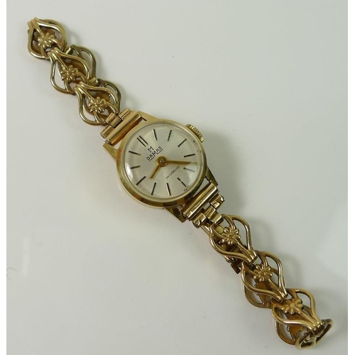 814 - A lady's 14ct gold watch with 9ct gold bracelet strap, the strap delicately formed with daisies to e... 