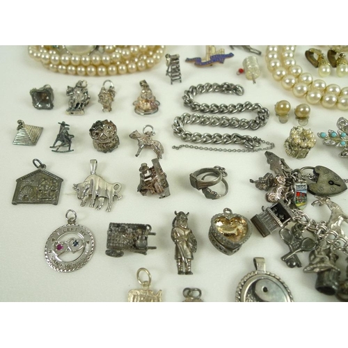 815 - A collection of jewellery including two silver charm bracelets with charms and further loose charms,... 