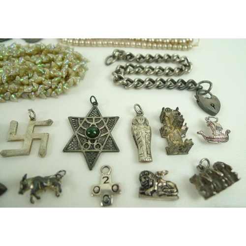 815 - A collection of jewellery including two silver charm bracelets with charms and further loose charms,... 