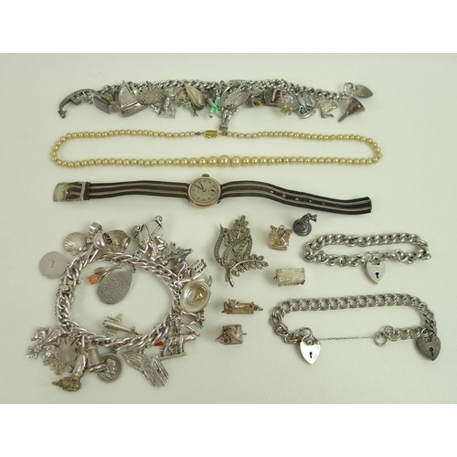 819 - A collection of jewellery, including two silver charm bracelets and some loose charms, approximately... 