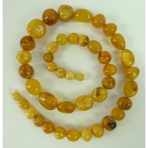 821 - A set of vintage amber beads of various colours including butterscotch, egg yolk and honey, the bead... 