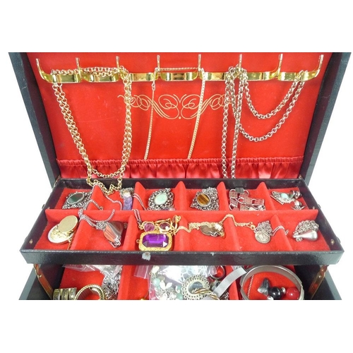 823 - A collection of costume jewellery in contained in a gilt tooled jewellery box, jewellery including a... 