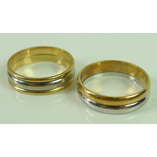 829 - A pair of 18ct gold and white gold swivel rings, 7.1g total weight, each size M. (2)